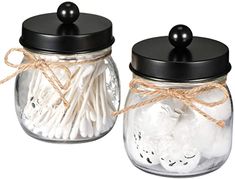 two glass jars filled with white cotton swabs