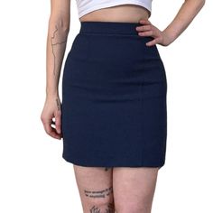 "Vintage '80s Christian Dior Boutique Paris couture wool mini skirt. Navy blue crepe-like exterior with synthetic lining (55% acetate / 45% cupro). High waisted with flattering tapered fit, zip and button closure in the back. Marked EU size 36, fits like XXS/XS, see measurements. Waist: ~24\"  Hips: ~34\" Length: ~18\" For reference, model is 5'6\" / 25\" waist / 38\" hips and usually wears an XS. Skirt fits but is too snug to move comfortably." Fitted Retro Style Mini Skirt, Retro Fitted High-waist Mini Skirt, Retro High-waist Fitted Mini Skirt, Retro Fitted High Waist Mini Skirt, Fitted High Waist Retro Mini Skirt, Retro High-waist Fitted Skort, Retro High Waist Fitted Skort, Retro Blue Fitted Skort, Retro Fitted Mini Skirt With Lining