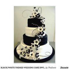 a black and white wedding cake decorated with flowers