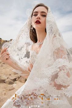 a woman wearing a wedding dress and veil