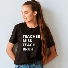 a girl with her hands on her hips wearing a teacher miss teach bruh t - shirt