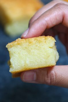 a person holding a piece of cake in their hand