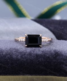 a black diamond ring sitting on top of a blanket