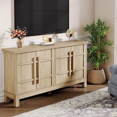 a living room with a large flat screen tv on top of a wooden entertainment center