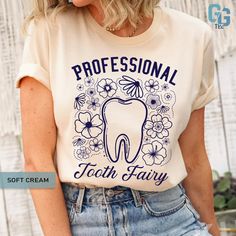 a woman wearing a white t - shirt with the words professional tooth fairy on it