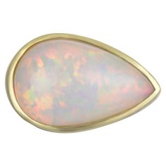 Experience luxury with Faye Kim's 18 Karat Gold Bezel Set Ethiopian Opal Ring. For those lucky enough to be born in October, here is a true one-of-a-kind treasure and the perfect birthstone ring. Lively color of play with red and green flashes. Architectural design, and perfectly stylish on any finger. Opal: 11 Carats Ring size 7.75, can be sized Made in the USA Vanilla Gelato, Born In October, Pear Shaped Ring, Ethiopian Opal Ring, Vintage Style Rings, Contemporary Ring, Jade Ring, Lightning Ridge, Domed Ring