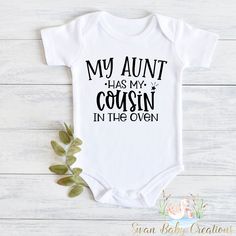 a white baby bodysuit that says, my aunt has my cousin in the oven