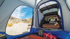 the inside of a tent with an open door and sleeping bag in front of it