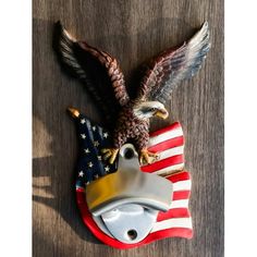 an eagle and american flag on a wooden surface with the word america written below it