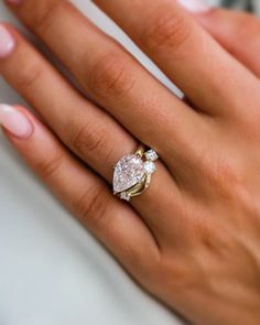 a woman's hand with a diamond ring on it