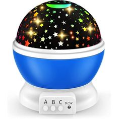 a blue and white night light with stars on the top is sitting on a stand