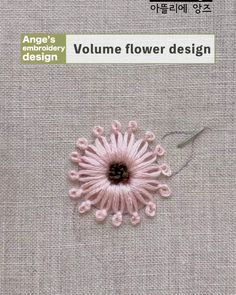 the cover of an article about flower design, featuring pink flowers and green leaves on grey fabric