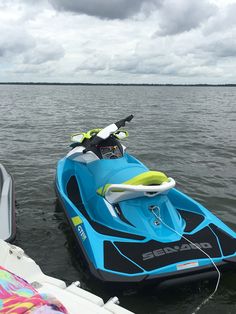 a blue and black jet ski sitting in the water