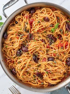 a pan filled with pasta and olives