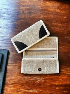 Women's Hemp Wallet (White with Dark Brown Accent) Our Hempalian (Himalayan) hemp wallet is made by using natural pure hemp yarns and fabric from the Himalayan regions of Nepal. Our wallets are THC free and eco-friendly. FEATURES: This wallet is 7 3/4" by 4" when closed by snap closure. It has three zippered compartments for storage. This wallet is fair trade handmade from durable hemp by artisans in Nepal. Color: White trim with Dark Brown Accent Many other options available in other listings Beige Bag With Coin Pocket For Daily Use, Beige Rectangular Wallets With Interior Card Slots, Beige Wallets With Interior Card Slots, Beige Rectangular Wallet With Interior Card Slots, Beige Wallet With Coin Pocket For Daily Use, Beige Rectangular Coin Purse With Interior Card Slots, Beige Rectangular Wallet With Coin Pocket, Beige Clutch Wallet As Gift, Beige Clutch Wallet As A Gift