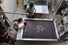 three people working on an art project in a studio