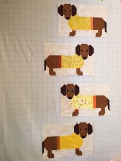 three pieces of paper cut out to look like dachshund dogs with yellow sweaters