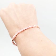 Radiating with the soft, warm hues of pink and rose, the Rhodochrosite Bead Bracelet 4mm is more than just a beautiful accessory—it's a symbol of love, compassion, and emotional healing. Rhodochrosite is known as the "Stone of the Compassionate Heart," revered for its ability to foster self-love, emotional balance, and deep inner healing. This delicate 4mm bead bracelet is designed for those who wish to carry the nurturing energy of Rhodochrosite with them wherever they go. Perfect for daily wea Pink Faceted Rondelle Beaded Bracelets, Pink Rose Quartz Bracelets For Meditation, Pink Rose Quartz Bracelet For Meditation, Minimalist Pink Round Bracelet, Pink Rondelle Gemstone Beads Bracelets, Hand-strung Pink Bracelets For Everyday Wear, Everyday Pink Hand-strung Bracelets, Dainty Pink Beaded Bracelets With Gemstone Beads, Pink Natural Stones Bracelet For Everyday