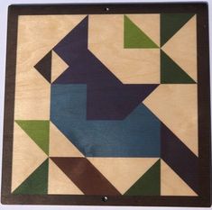 a wooden wall hanging with geometric designs on it