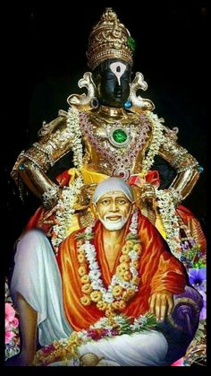 a statue of the hindu god sitting in front of a black background with flowers around it