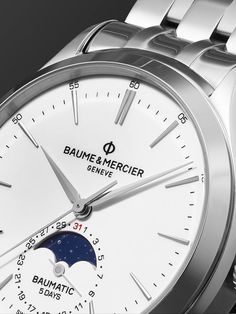 Favoured for its classic and understated design, this version of Baume & Mercier's 'Clifton' watch is fitted with a clean white dial that's detailed with rhodium-plated indices and hands and a traditional moon-phase indicator. It's been carefully crafted in Switzerland from stainless steel and has a precise in-house Baumatic BM14-1975A C1 automatic movement that can be seen through the exhibition case back. We offer a two-year warranty for all working parts and manufacturing faults for luxury w… Timeless White Watch Accessories With Polished Finish, Business White Watches With Date Indicator, White Business Watches With Date Indicator, Timeless White Watches, Timeless White Round Dial Watch Accessories, Timeless White Watch Accessories With Round Dial, Elegant White Watch With Tachymeter, Timeless White Chronometer Watch Accessories, White Polished Business Watches