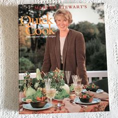 the cover of martha stewart's quick and cook magazine, featuring a woman standing in front of a table full of food