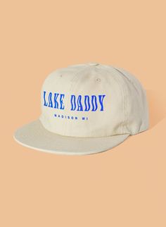 "\"Lake Daddy\" printed in blue on brushed eggshell cotton, six-panel unstructured hat. Brushed Cotton Twill Fabric Fabric Strap with Brass Metal Closure One size fits most - 58 cm" Merch Hats, Unstructured Hat, Boat Hat, Screen Printed Fabric, Concert Fits, Fabric Strap, Outfits With Hats, Kids Swimming, Tan Lines