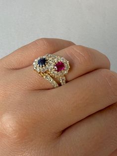 Antique 18k yellow gold ring featuring 36 old cut diamonds surrounding a crossover of sapphire and ruby central stones. Great antique condition Size: 6.25 resizable* Weight: 4.6 grams Band: 16.0 mm (front), 3.3 mm (back) Ruby: 5.0 mm x oval cut Sapphire: 5.0 mm x oval cut Diamonds: 2.0 mm x 36 old round cuts Ruby Halo Engagement Ring, Ruby And Sapphire Ring, Aquamarine Stone Ring, Antique Ruby Ring, Ruby Wedding Rings, Ring Ideas, Aquamarine Stone, Ruby Jewelry, Ruby Sapphire