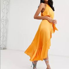 Halter Neck Wrap Tie Ruffle Dress In Orange Satin Orange Dress, Blue High Low Dress, High Low Prom Dress, Short Sleeve Lace Dress, Floral Wrap Maxi Dress, High Low Midi Dress, Belted Wrap Dress, Wrap Front Dress, Plunge Dress