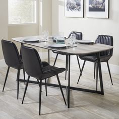 a dining room table with four chairs around it