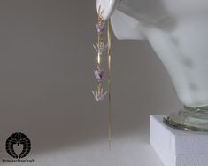 Elegant two floors threader earrings with delicate hand folded lavender origami cranes.  Small and light cranes to match the dangling thread design. The cranes are so light, you will hardly notice wearing them.  Earring thread is 14 cm.  The approximately size of crane is 1.3cm (0.5") wing span. The cranes are lacquered many times and will withstand for instance rain.  Although this is made of paper, it's fairly solid. Earring thread hooks are 18K gold on 925 sterling silver base. Lavender Origami, Gold Thread Earrings, Constellation Jewelry, Origami Cranes, Grape Earrings, Thread Design, Bottle Earrings, Minimal Earrings, Thread Earrings