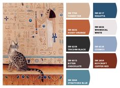 a cat sitting on top of a table next to an egyptian wallpaper and color swatches