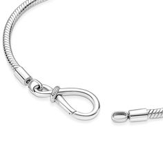 Inspired by the bond between a mother and child, the Pandora Moments Infinity Knot Snake Chain Bracelet features an asymmetrical infinity knot that serves as the clasp. Two raised threads divide the bracelet into three sections. This symbol of eternal love can be worn on its own or personalized with one charm or dangle charm on the clasp and 14–16 charms, dangle charms or pendants on the rest of the bracelet. Bracelets Collection, Infinity Knot, Bracelet Pandora, Snake Chain Bracelets, Knot Bracelet, Pandora Bracelets, Dangle Charms, Pandora Bracelet, Eternal Love