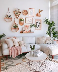 a living room filled with furniture and lots of plants on the wall next to a window