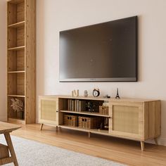 a flat screen tv mounted to the side of a wooden entertainment center in a living room