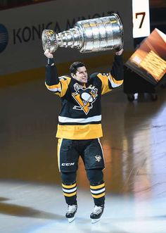 a hockey player holding up the stanley cup