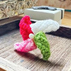 three small crocheted objects sitting on top of a table