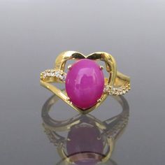 Vintage 18K Solid Yellow Gold Star Ruby & White Topaz Heart Ring ....Marked 18K...Total of weights 3.1grams...Size 7.5...With 01 Oval Star Ruby 10 x 8MM ( 2.54ct ) And 12 Round cut White Topaz's 1.3MM ( .01ct x 12 = .12ct ) Measure of Face 13.3MM...It's in very good condition. Gold Ruby Ring With Gemstone Accents For Anniversary, Gold Heart Ring With Oval Gemstone, Gold Heart Ring With Gemstone, Heart-shaped Yellow Gold Jewelry With Center Stone, Heart Shaped Yellow Gold Jewelry With Center Stone, Gold Heart Ring With Gemstone For Valentine's Day, Gold Heart Ring With Accent Stones Fine Jewelry, Yellow Gold Oval Heart Ring With Gemstone, Gold Ruby Ring With Gemstone For Valentine's Day