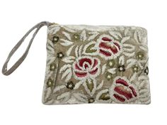 an embroidered pouch with flowers and leaves on the front, hanging from a gray cord