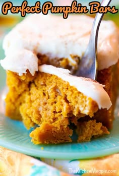 a piece of pumpkin bars on a plate with a fork in it and the bite taken out