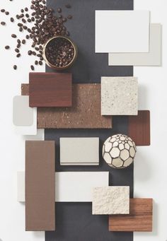 an assortment of different types of tiles and materials on a table with coffee beans in a bowl