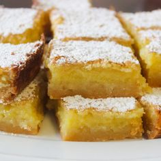 several pieces of cake on a plate with powdered sugar