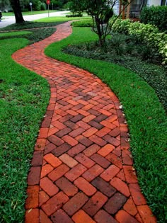 a red brick path in the grass