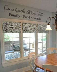 a dining room table with chairs and a chandelier hanging from the ceiling