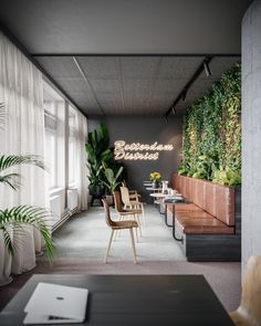 an office lobby with plants on the wall