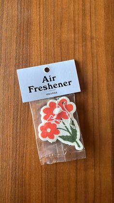 an air freshener sticker sitting on top of a wooden table