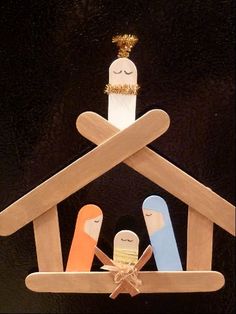 an ornament made to look like a house with three people in the roof