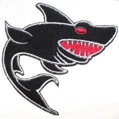 a white t - shirt with a shark's teeth on it