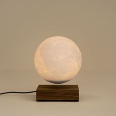 a white light sitting on top of a wooden stand