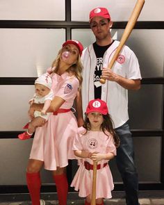 a man, woman and child dressed up as baseball players